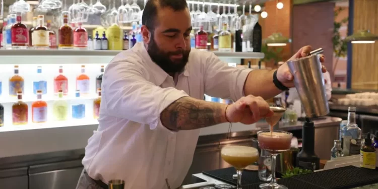 A bar tender mixes a non-alcoholic cocktail at a pop-up bar in Riyadh. But the real stuff could soon be heading to the Saudi capital.