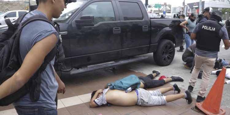 Men lie face down on the ground, detained by police outside TC Television, after a producer told police that they were part of a group who broke onto their set on live TV. Cesar Munoz/Copyright 2024. The AP. All rights reserved
© Provided by Africanews