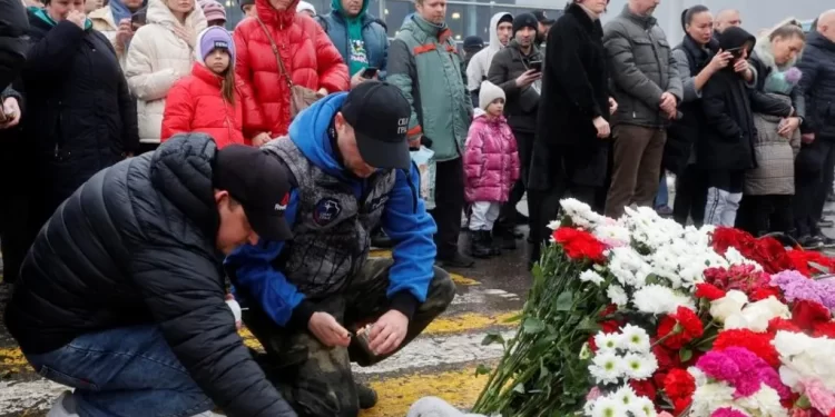 Flowers were laid at a makeshift memorial outside the concert hall on Saturday