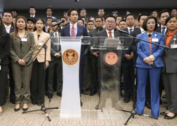 FILE - Move Forward party’s leader Chaithawat Tulathon, center right, with its former leader Pita Limjaroenrat, center left, talks to reporters during a news conference at parliament in Bangkok, Thailand, on Jan. 31, 2024. Thailand’s Election Commission on Tuesday, March 12, said it will seek the dissolution of the progressive Move Forward party which won last year’s general election after a court ruled that the party’s proposal to amend a royal anti-defamation law was unconstitutional. (AP Photo/Sakchai Lalit, File)