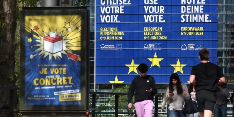 FREDERICK FLORIN/AFP Pedestrians walk pass a giant poster announcing the upcoming European elections, stuck on the facade of the European Parliament building, in Strasbourg, eastern France, on April 10, 2024. The European Parliament elections are planned to be held from June 6 to 9, 2024FREDERICK FLORIN/AFP
European Parliament elections take place from 6-9 June in 27 different EU member states