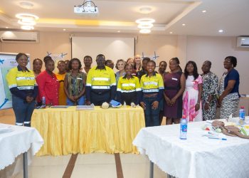 Newmont and Project C.U.R.E officials with health professionals
