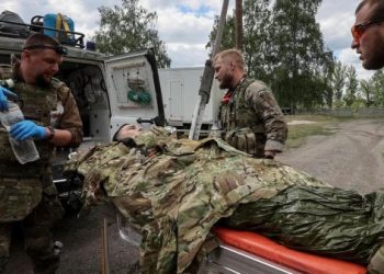 Military paramedics treat a wounded Ukrainian service member, amid Russia's attack on Ukraine, near the town of Vovchansk