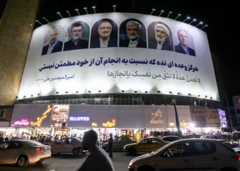 Vehicles move past a billboard displaying the faces of the six candidates running in the Iranian presidential election, in Valiasr Square, central Tehran, Iran on June 17. Atta Kenare/AFP/Getty Images