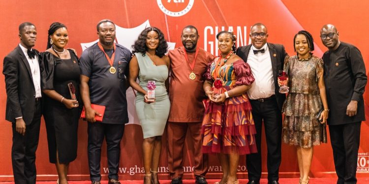 Staff of Serene Insurance in a group photograph pose with the awards won at the 7th Ghana Insurance Awards at the Labadi Beach Hotel in Accra.