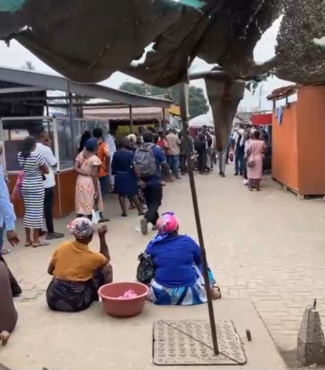 Passengers in a long queue at a trotro station, Accra